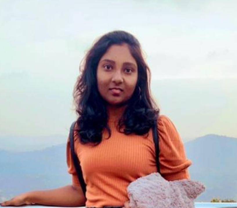 Girl posing in front of mountains in the distance